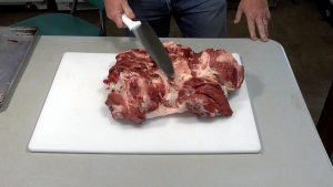 Fully boned Wild Hog Ham laying on a cutting board